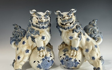 A LARGE PAIR OF VINTAGE BLUE AND WHITE PORCELAIN ORIENTAL FOO DOGS