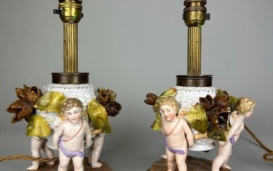 A PAIR OF DRESDEN PORCELAIN TABLE LAMPS, DEPICTING WINGED...