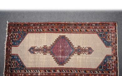 A Persian rug, red and blue central stepped medallion on a pole