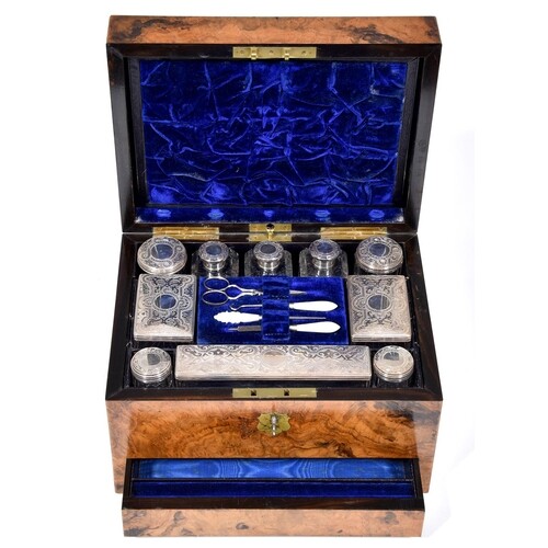 A Victorian silver-fitted walnut dressing case, lined in blu...