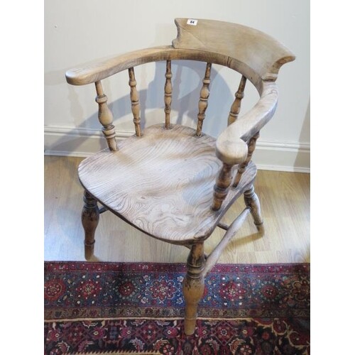 A Victorian smokers bow armchair with double turned stretche...