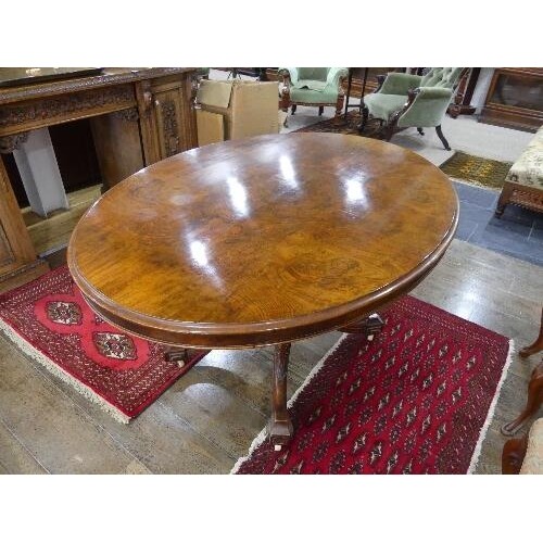 A Victorian walnut oval Breakfast Table, quarter veneered to...