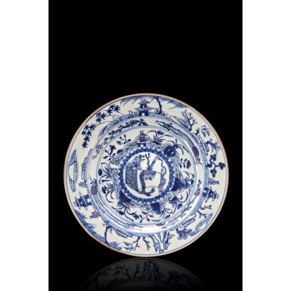 A blue and white porcelain plate, decorated with pagodas and shrubs (slight defects) China, Qing dynasty, Kangxi period (1662-1722) (d....