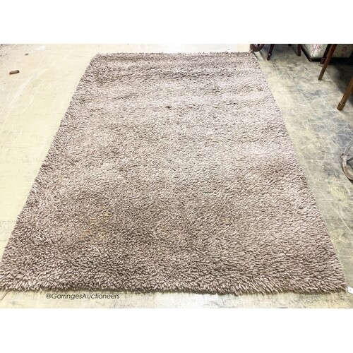 A contemporary brown shag pile carpet, 300 x 200cm ...