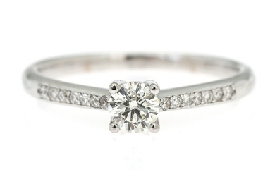NOT SOLD. A diamond ring set with a brilliant-cut diamond flanked by numerous diamonds, mounted...