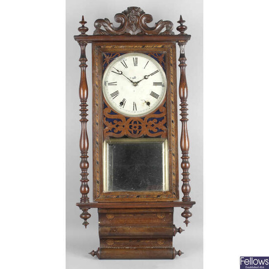 A late 19th century stained mahogany wall hanging clock.