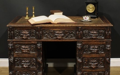 A late Victorian oak twin pedestal desk, rectangular top wit...