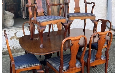 A mahogany dining table with twin pedestal and eight chairs ...