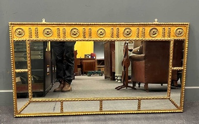A neoclassical style gilt painted sectional overmantel mirror, the freize decorated with repeating