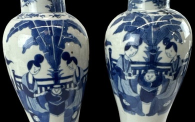 A pair of Chinese blue and white porcelain vases decorated...