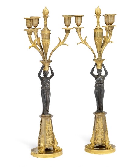 A pair of Empire gilt and patinated bronze candelabra. French, early 19th century. H. 56 cm. W. 22 cm. (2)