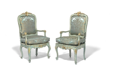 A pair of Italian Rococo green painted and gilt decorated armchairs. Mid-18th century. (2)