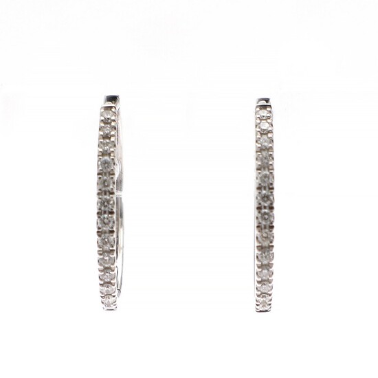 A pair of diamond ear pendants each set with numerous brilliant-cut diamonds weighing a total of app. 0.26 ct., mounted in 18k white gold. L. app. 1.9 cm. (2)