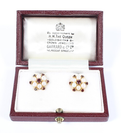 A pair of early 20th century 9ct gold garnet and seed pearl earrings of star shaped form