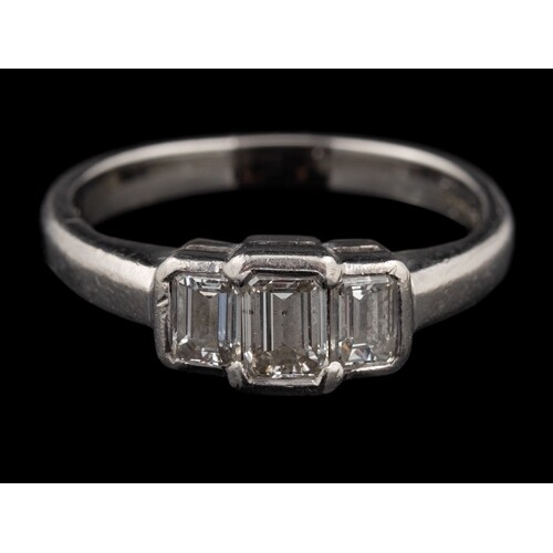A platinum diamond three stone ring,: the central rectangula...