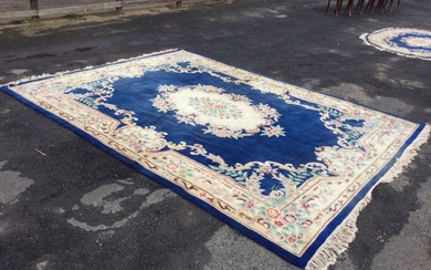 A rectangular Chinese aubusson style rug with central floral medallion...