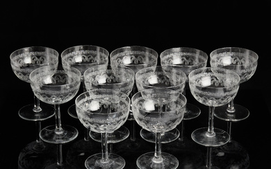 A set of 11 clear glass champagne cups with pantographed decor, early 20th century.