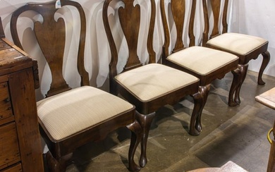 A set of four Chippendale style mahogany dining chairs with cream seats
