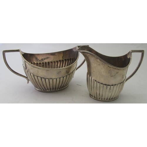 A silver cream jug and matching sugar bowl, with 1/2 fluting...