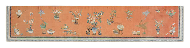 AN APRICOT-GROUND SILK-EMBROIDERED 'HUNDRED ANTIQUES' TEXTILE