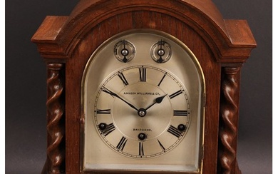 An early 20th century oak bracket clock, 14.5cm arched silve...