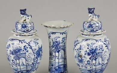An earthenware garniture set decorated with floral motifs, Delft, 18th century.