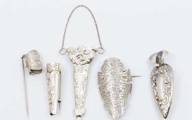 Boutonnieres: a collection of four mixed silver or white metal...