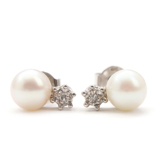 Bræmer-Jensen: A pair of pearl and diamond earrings each set with single-cut diamond and cultured pearl, mounted in 14k white gold. (2)