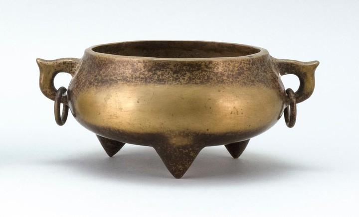 CHINESE BRONZE CENSER With two loose ring handles and trifoot base. Uneven patina. Four-character mark on base.