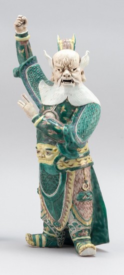 CHINESE FAMILLE VERTE AND BISQUE GLAZE PORCELAIN FIGURE In the form of a demon in military garb. Height 15.5".