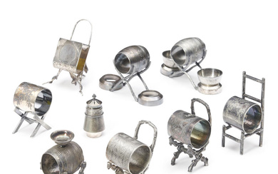 EIGHT SILVER-PLATED NAPKIN RINGS ON CHAIRS AND STOOLS