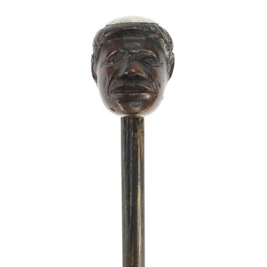 Ebonised walking stick with carved head pommel and