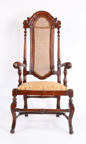 Late 17th Century walnut and beech armchair, the arched top rail above the caned back flanked by