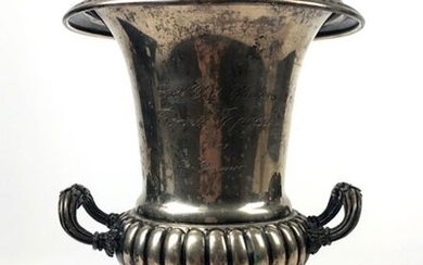 Medici silver vase decorated with gadroons in relief and palmettes, the square-section pedestal decorated with canals.