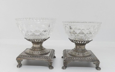 Pair of SALERONS, the glassware is diamond-tipped, set in silver, the square base underlined by a frieze of grapes of hearts resting on four small claw feet. Old man's stamp. Gross weight 376 g