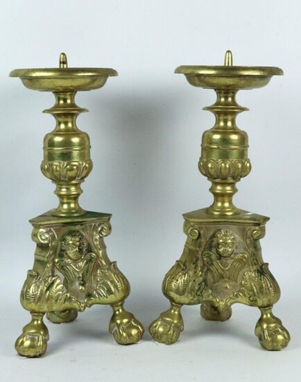 Pair of cast and chiselled brass picks, the base decorated with an angel.
