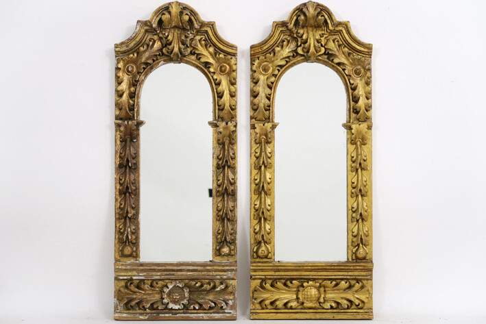 Pair of mirrors each in an antique baroque style frame in decorated and sculpted wood - 80 x 31 ||pair of mirrors each in an antique baroque style frame in guilded and sculpted wood