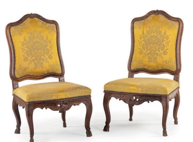 Pair of moulded and carved walnut chairs with...