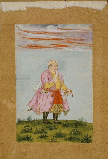 Raja Udai Singh (Mota Raja) of Marwar, Rajasthan, North India, early 19th century, opaque and transparent pigments heightened with gold on paper, standing facing right, wearing a pink jama, a jewelled turban, he stands on on grassy ground, small...