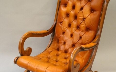 Rocking chair in leather upholstered in Victorian style with toe....