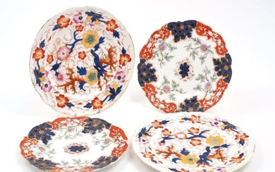 Two pairs of unmarked cabinet plates, 19th century, the first decorated with yellow and pink flowers, trees and red and blue leaves, 25cm diameter, the second with blue and red paneled border and flowering bamboo branches to the center, 22cm...