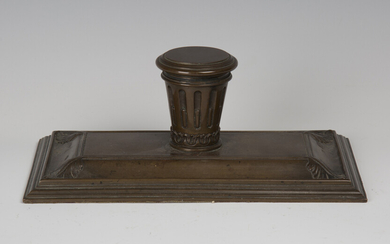 A 19th century brown patinated cast bronze inkstand, the central stop fluted inkwell with hinged lid