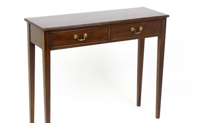 A 20thC mahogany console table / side table with a reeded ed...