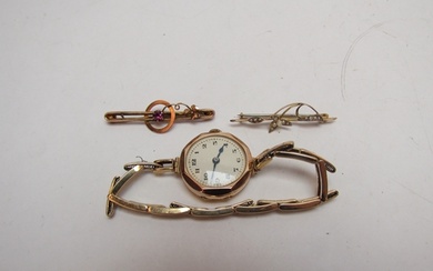 A 9ct gold cased lady's watch and two 9ct gold brooches, one...