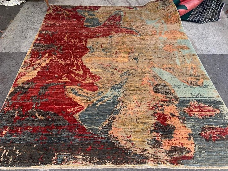 A CONTEMPORARY STYLE RUG IN PIXELATED DESIGN IN TONES OF RED, YELLOW AND GOLD