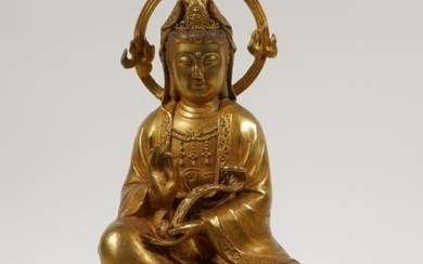 A Chinese gilt bronze figure of Quan Yin holding...