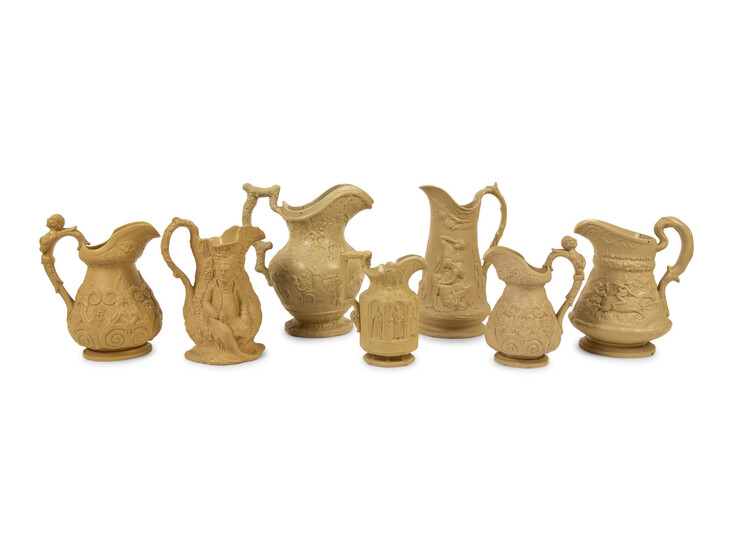 A Collection of Seven English Salt Glazed Relief Form Pitchers