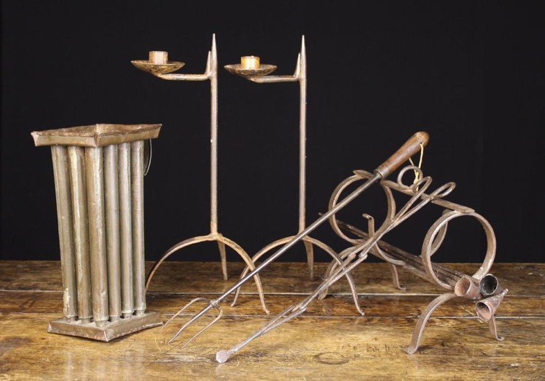 A Collection of Wrought Iron-ware: A 2½ ring pipe kiln, three pipe shaped candle snuffers, a 19th ce