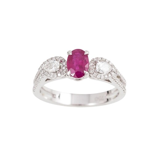 A DIAMOND AND RUBY DRESS RING, the oval ruby flanked by pear...