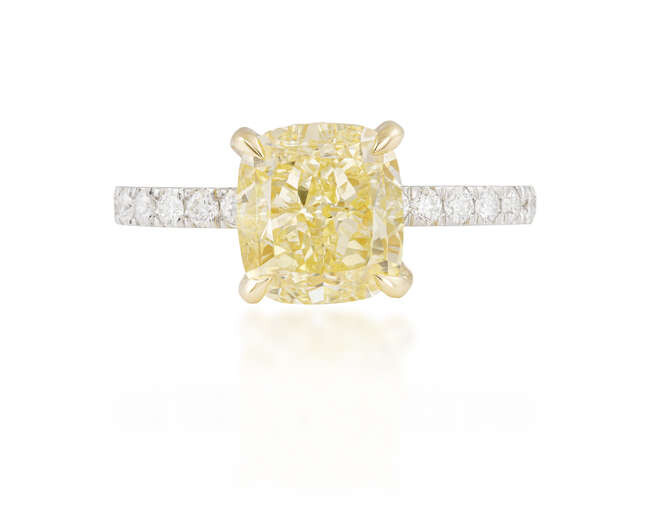 A FANCY-COLOURED DIAMOND AND DIAMOND RING The cushion-shaped...